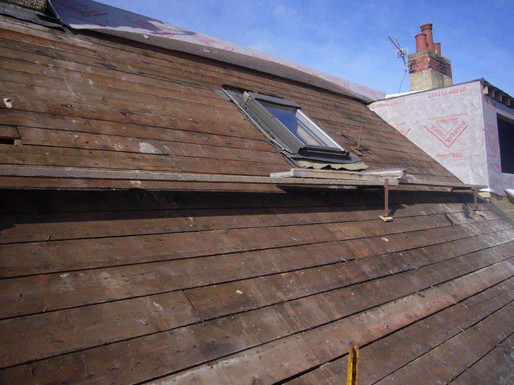 New tiled roof being installed on a detached house
